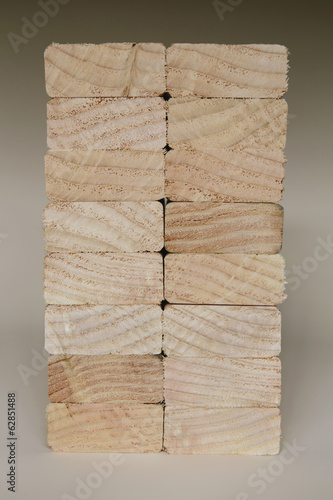 Foto: Stack of sawn prepared timber, spruce wood planks or studs, for use. Treated wood in traditional 2 by 4 measured cut shapes. Cut ends. Stack of sawn prepared timber, spruce wood planks or studs, for use. Treated wood in traditional 2 by 4 measured cut shapes. Cut ends.