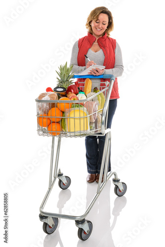 Photo: Woman food shopping with trolley isolated Woman food shopping with trolley isolated