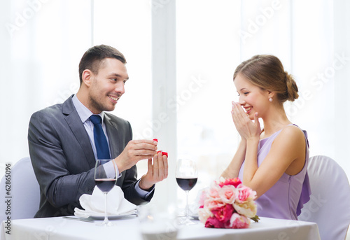 Photo: man proposing to his girlfriend at restaurant man proposing to his girlfriend at restaurant