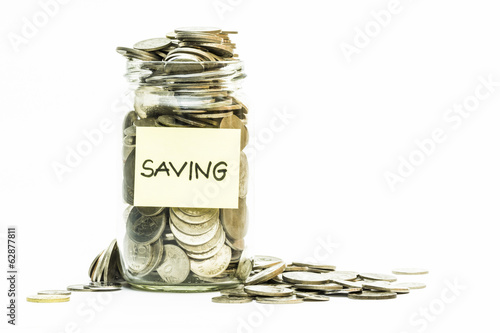 Photo: Isolated coins in jar with saving label Isolated coins in jar with saving label