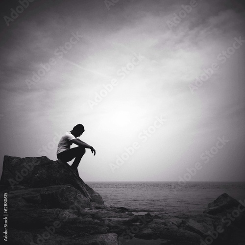 Instant Collection: man sitting alone on the beach man sitting alone on the beach