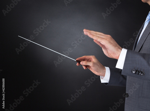 Photo: Orchestra Conductor Holding Baton Orchestra Conductor Holding Baton