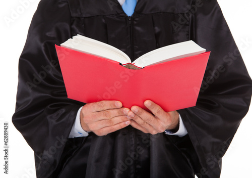 Photo: Judge Holding Statute Book Judge Holding Statute Book