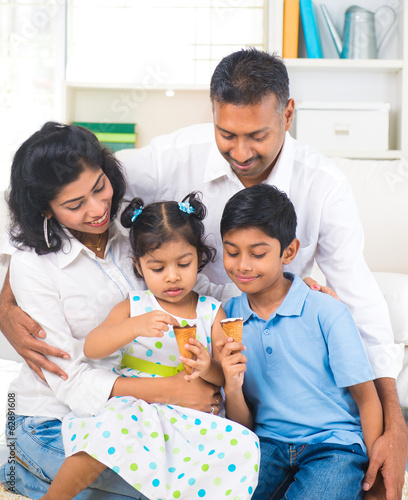Photo: indian family enjoying eating ice cream indoor indian family enjoying eating ice cream indoor