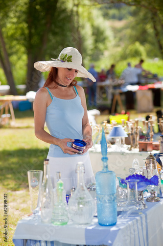 Photo: Woman buying antique collectibles, Provence, France. Woman buying antique collectibles, Provence, France.