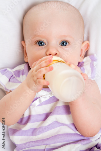 Photo: adorable child drinking from bottle adorable child drinking from bottle