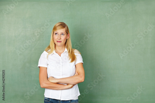 Photo: Woman as teacher in front of chalkboard Woman as teacher in front of chalkboard