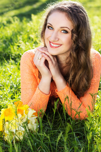 Photo: Happy smiling girl with yellow flowers Happy smiling girl with yellow flowers