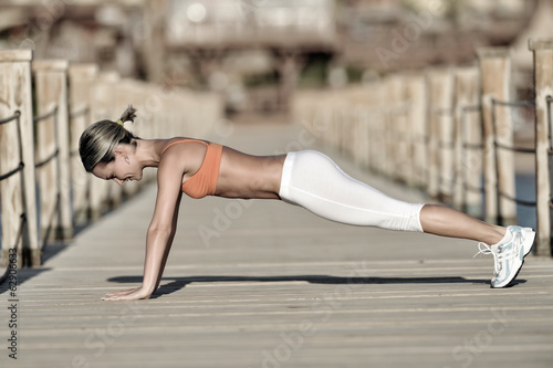 Photo: young woman exercising outdoor in summer young woman exercising outdoor in summer
