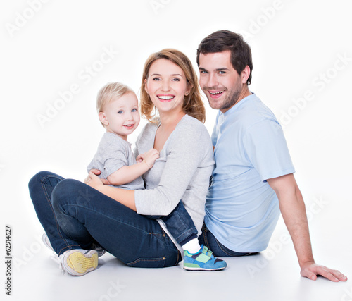 Photo: Happy young family with little child. Happy young family with little child.