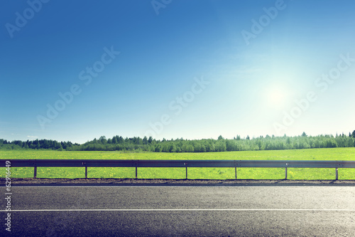 Photo: road and field of spring grass road and field of spring grass