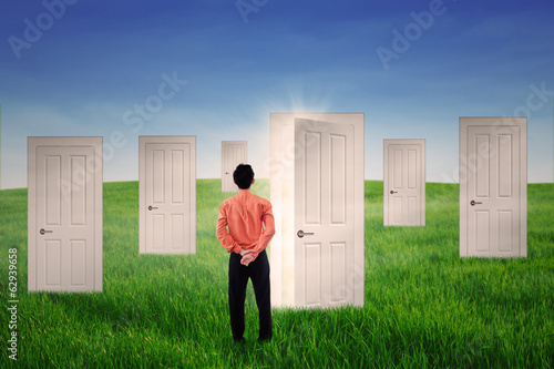 Photo: Businessman with opportunity doors Businessman with opportunity doors