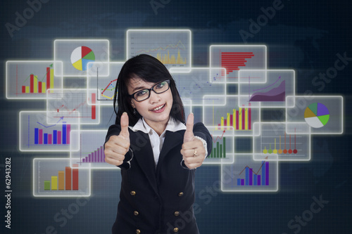 Photo: Pleased businesswoman giving thumbs up Pleased businesswoman giving thumbs up