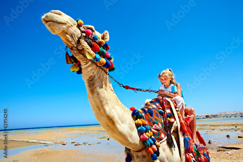 Photo: Tourists riding camel on the beach of Egypt. Tourists riding camel on the beach of Egypt.