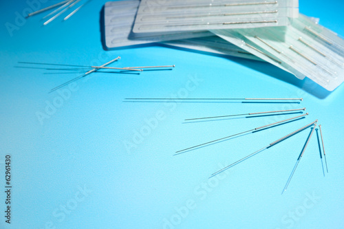 Photo: Needles for acupuncture on blue background Needles for acupuncture on blue background
