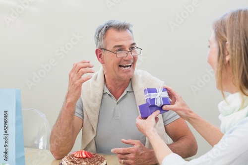Photo: Cheerful man receiving a gift Cheerful man receiving a gift