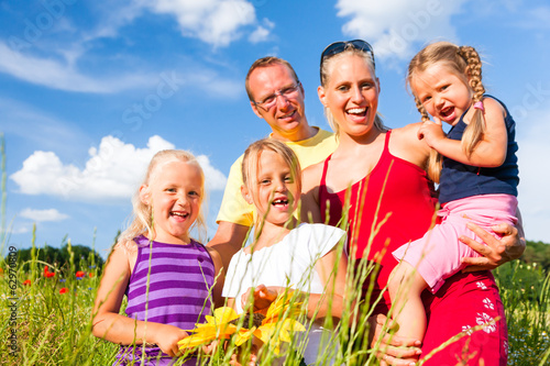 Photo: Family in grass in summer Family in grass in summer