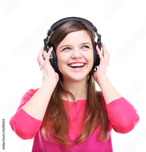 Photo: Woman with headphones listening music on player Woman with headphones listening music on player