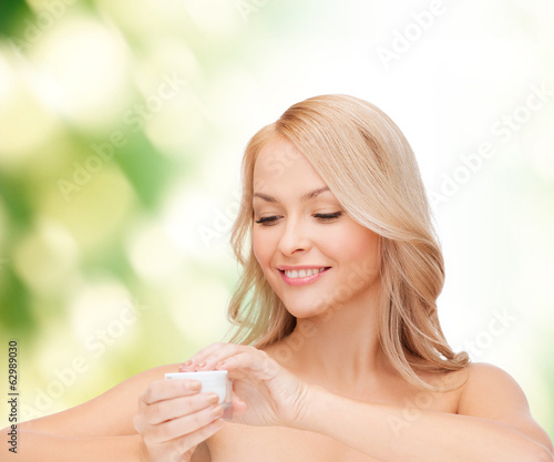 Photo: beautiful woman applying cream beautiful woman applying cream