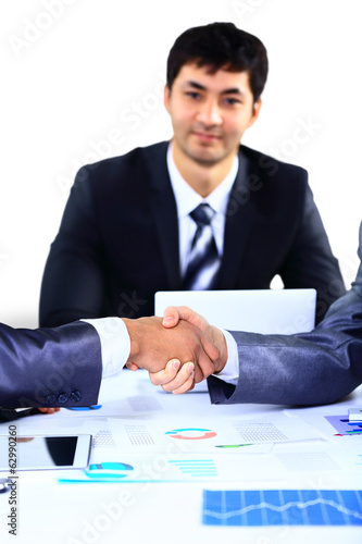 Photo: businessman shaking hands to seal a deal with his partner businessman shaking hands to seal a deal with his partner