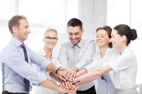 Photo: business team celebrating victory in office business team celebrating victory in office