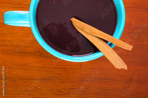 Photo: red soup on bowl in a wood background red soup on bowl in a wood background