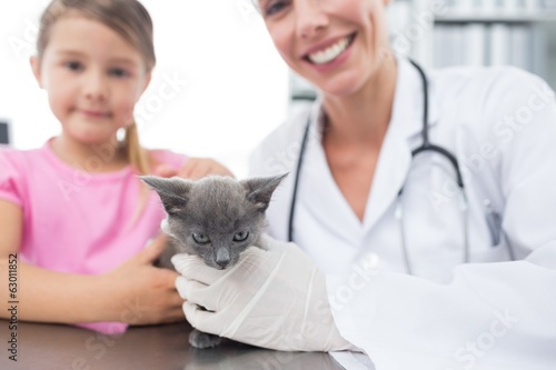 Photo: Veterinary and girl with kitten in hospital Veterinary and girl with kitten in hospital