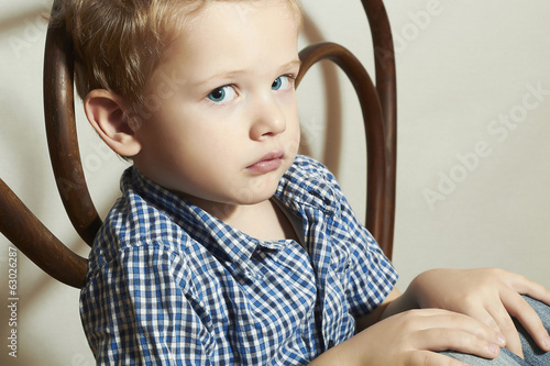 Photo: Child. Sad little boy.Fashion Children.Emotion Child. Sad little boy.Fashion Children.Emotion