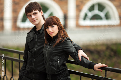 Photo: Happy young couple in leather jackets outdoor Happy young couple in leather jackets outdoor