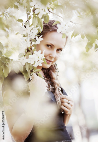 Photo: Beautiful woman in a spring garden Beautiful woman in a spring garden