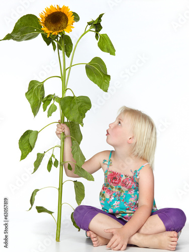 Photo: Cute blond child with sunflower Cute blond child with sunflower