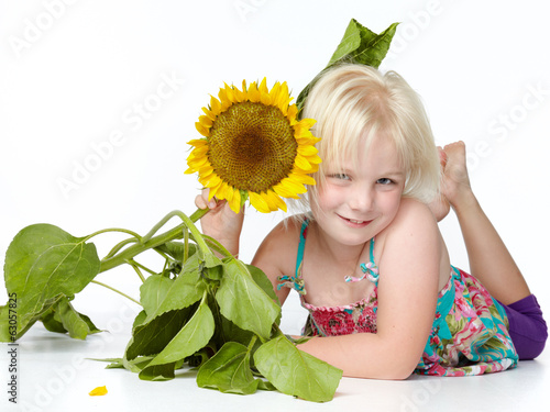 Photo: Cute blond child with sunflower Cute blond child with sunflower