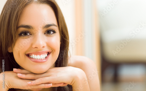 Photo: Portrait of young woman at home Portrait of young woman at home