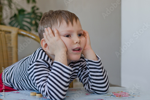 Photo: Young boy watching with curiosity Young boy watching with curiosity