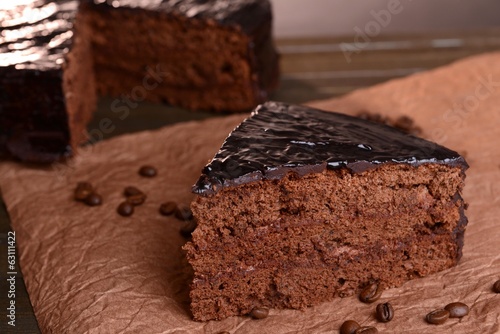 Photo: Delicious chocolate cake on table close-up Delicious chocolate cake on table close-up