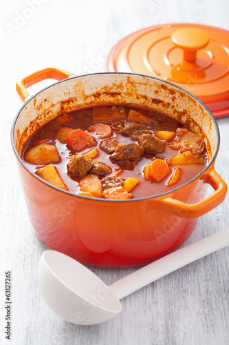 Photo: beef stew with potato and carrot in red casserole beef stew with potato and carrot in red casserole