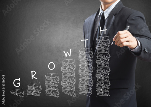 Photo: Business man writing growth concept Business man writing growth concept