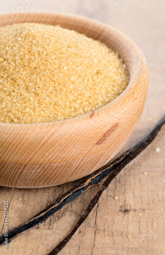 Photo: vanilla pods and brown cane sugar in a bowl vanilla pods and brown cane sugar in a bowl