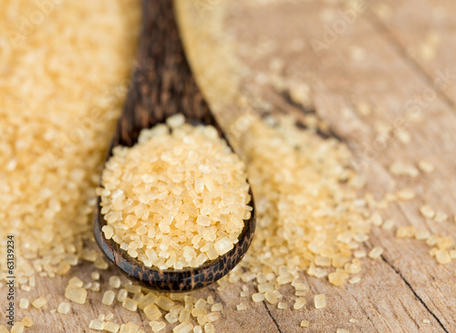 Photo: brown cane sugar in a wooden spoon brown cane sugar in a wooden spoon