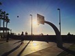 Street Basketball Players playing at an Outdoor Beachside Court Street Basketball Players playing at an Outdoor Beachside Court