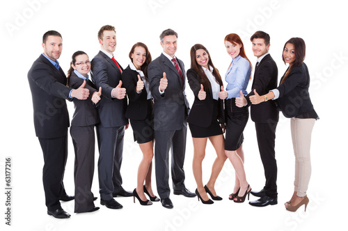 Photo: Business people showing thumbs up sign Business people showing thumbs up sign