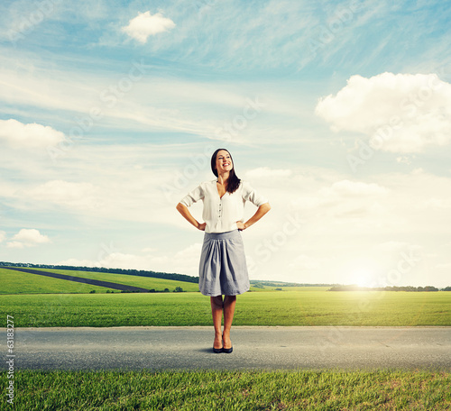 Photo: young woman standing on the road young woman standing on the road