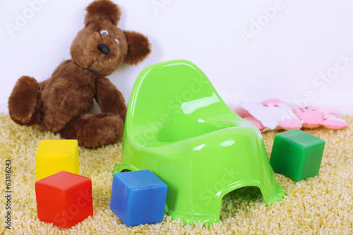 Photo: Green potty on home interior background Green potty on home interior background