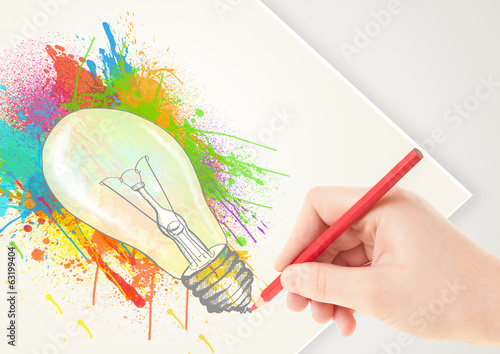 Photo: Hand drawing on paper a colorful splatter lightbulb Hand drawing on paper a colorful splatter lightbulb