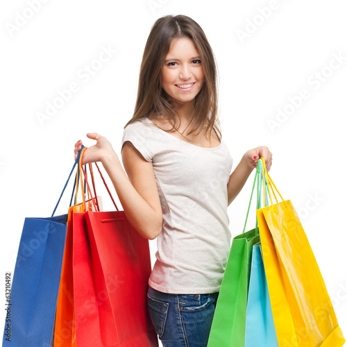 Photo: Smiling woman with shopping bags isolated on white Smiling woman with shopping bags isolated on white