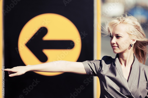 Photo: Young woman pointing a direction Young woman pointing a direction