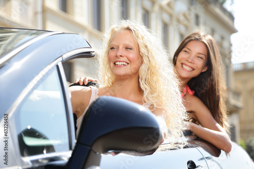 Photo: Car driver woman driving with girl friends Car driver woman driving with girl friends