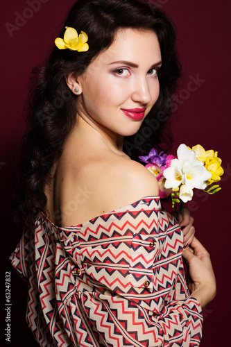 Photo: Pretty brunette lady with fresia flowers Pretty brunette lady with fresia flowers