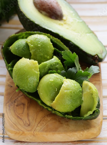Photo: salad of fresh avocado on a wooden board salad of fresh avocado on a wooden board