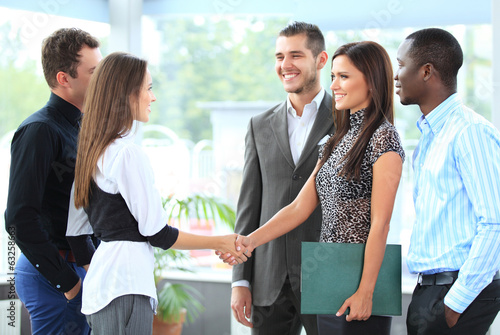 Photo: Business people shaking hands, finishing up a meeting Business people shaking hands, finishing up a meeting